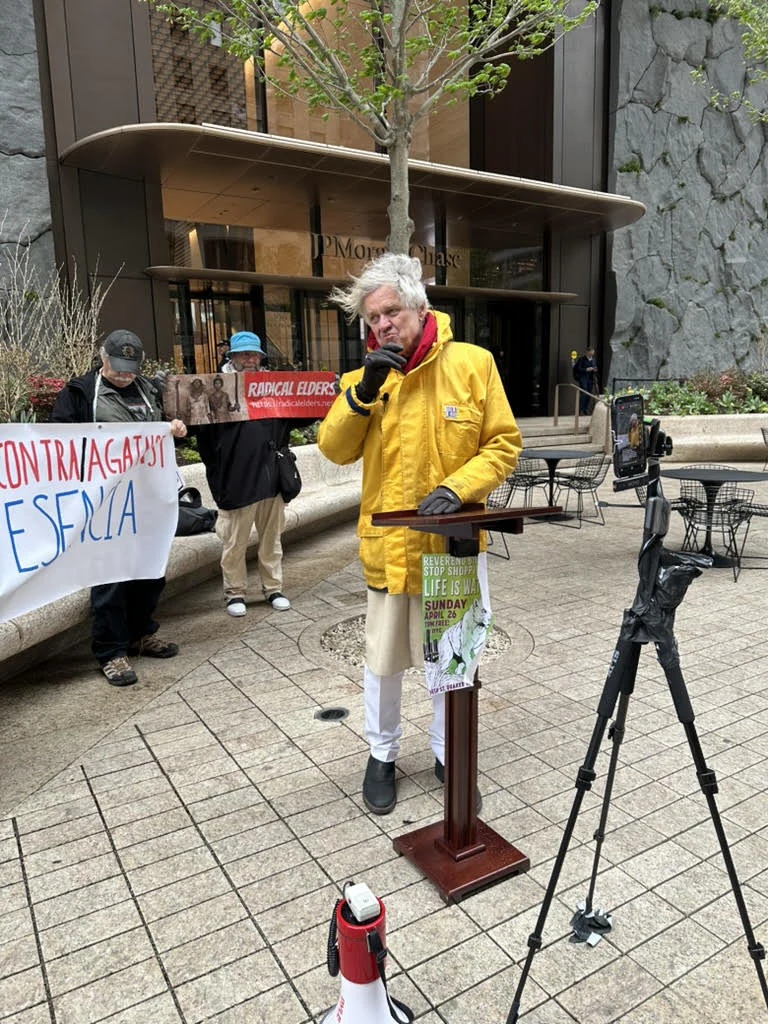 Reverend Billy speaking outside a JPMorgan Chase building