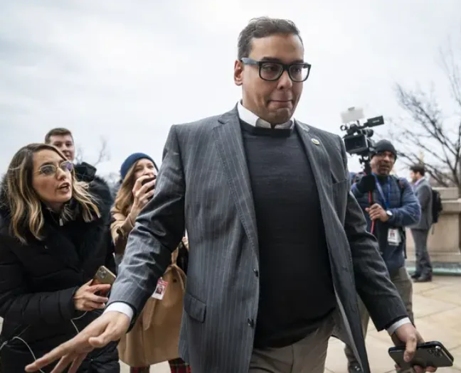 George Santos walking past reporters