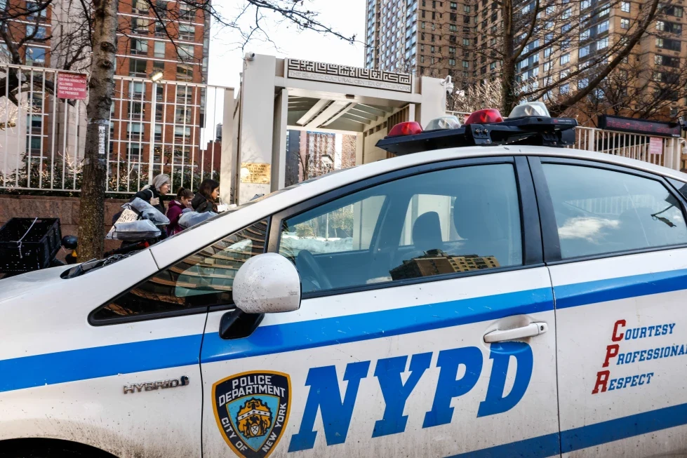 An NYPD vehicle parked outside a Queens cultural center